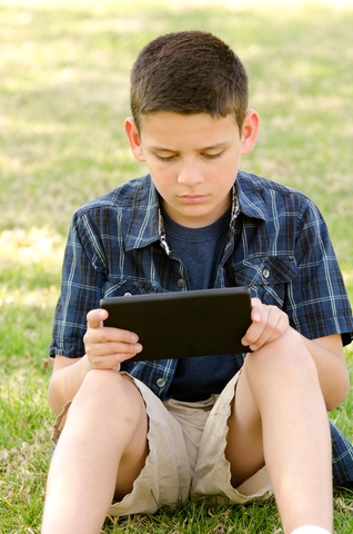Boy reading on a tablet